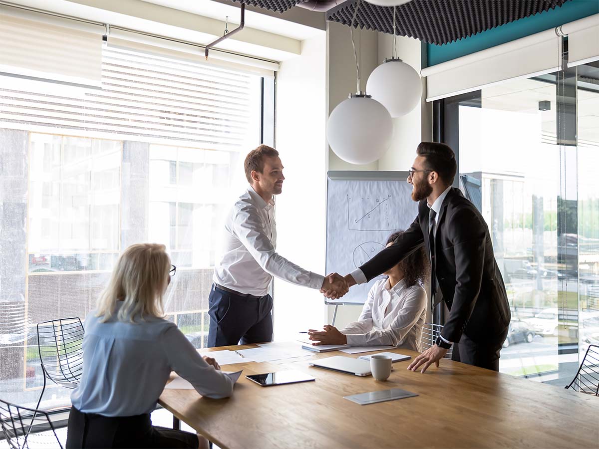 business handshake in the boardroom