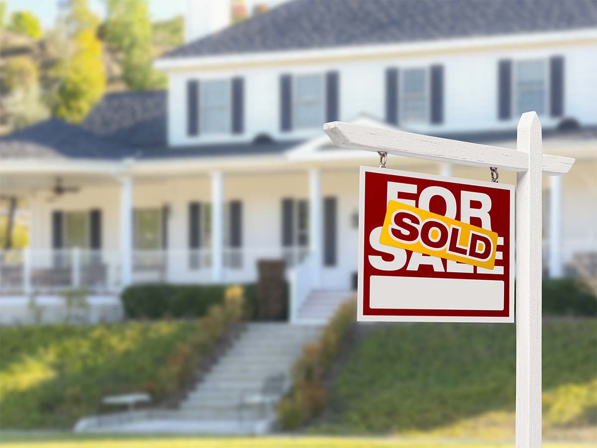 SOLD sign in front of house