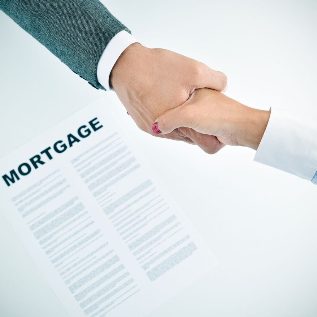 People shaking hands over mortgage