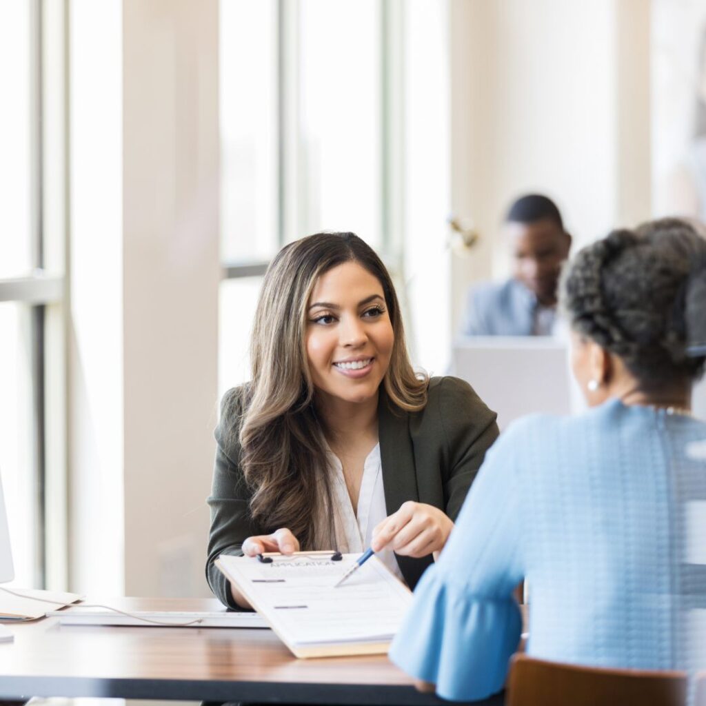 Lender smiling while working on paperwork