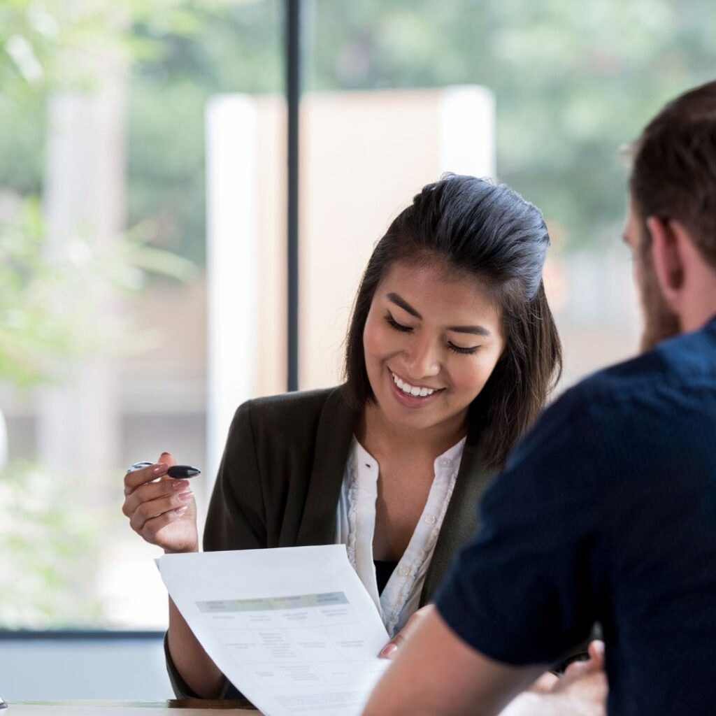 Lender smiling while working on paperwork