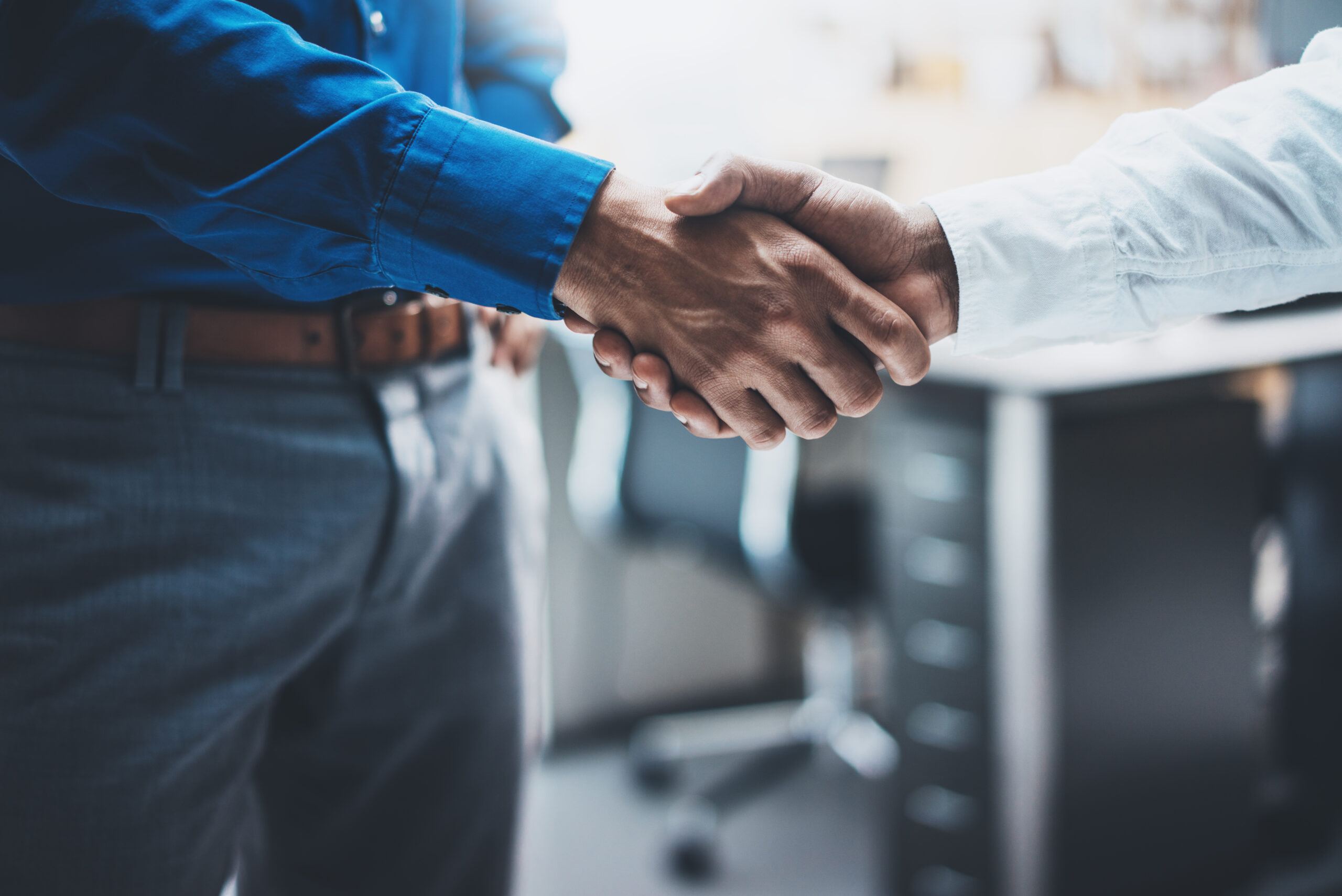 Business partnership handshake concept.Image of two businessmans handshaking process.Successful deal after great meeting.Horizontal, blurred background