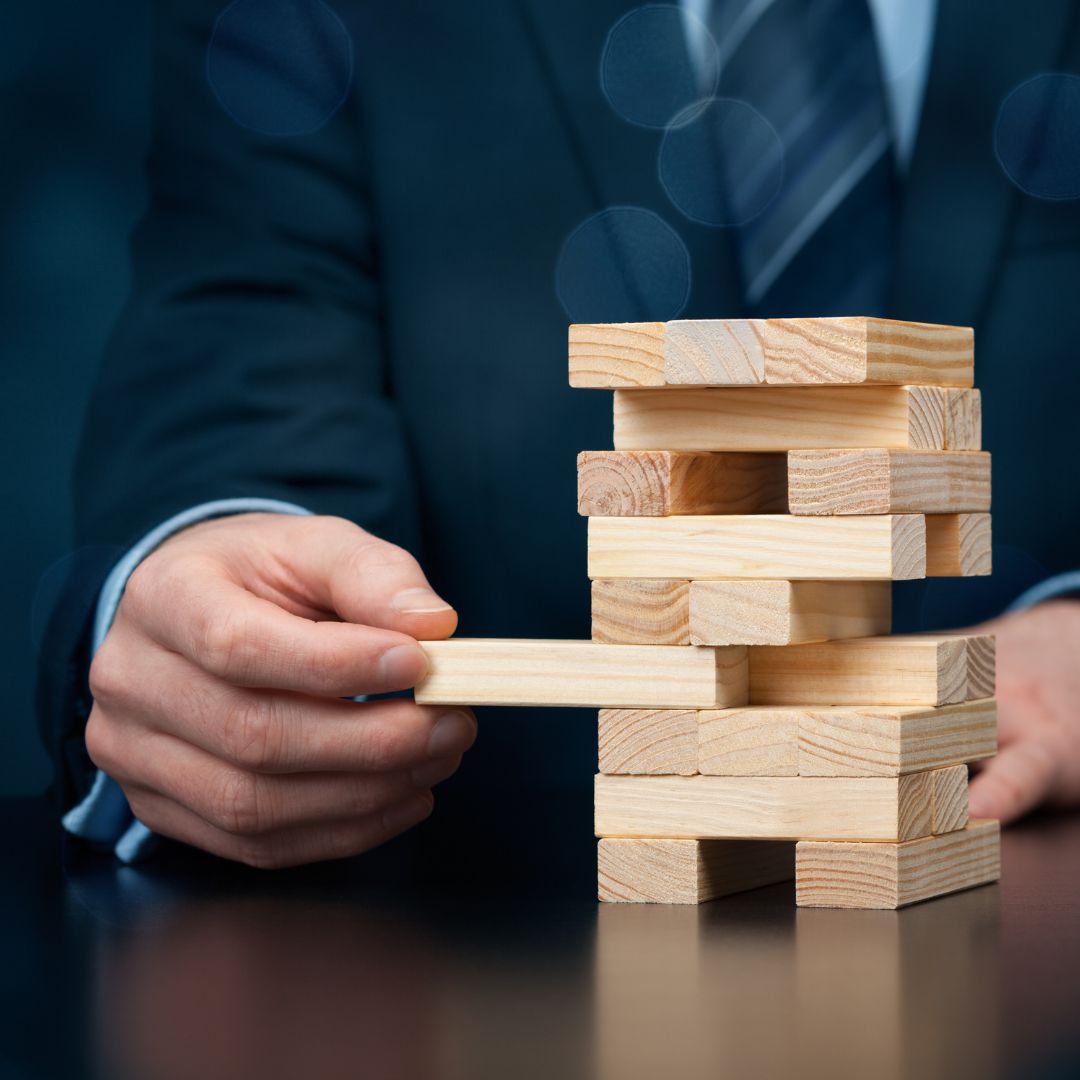Businessman playing jenga