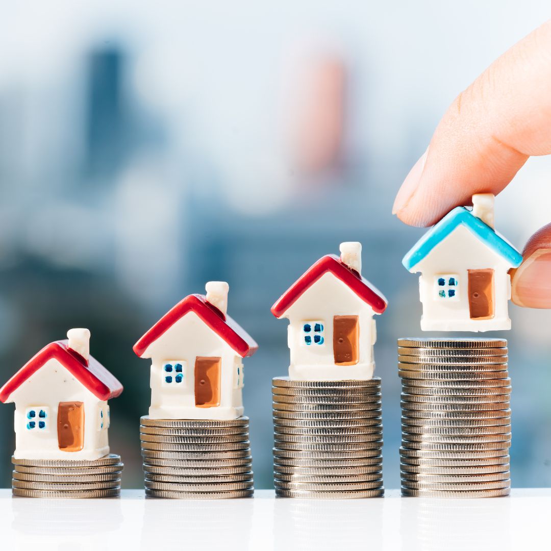 tiny houses on stacks of money