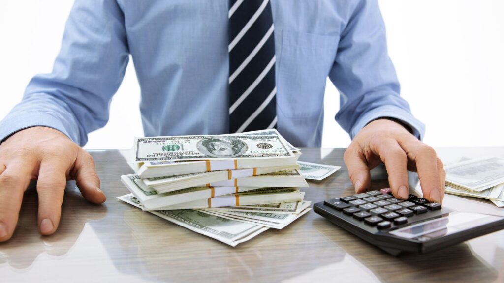 Person with money and a calculator