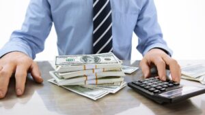 Person with money and a calculator