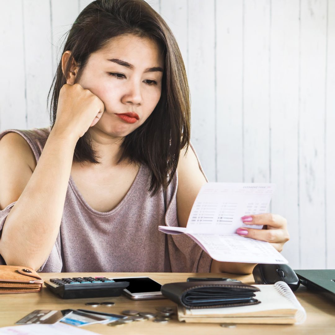girl looking at her checkbook 