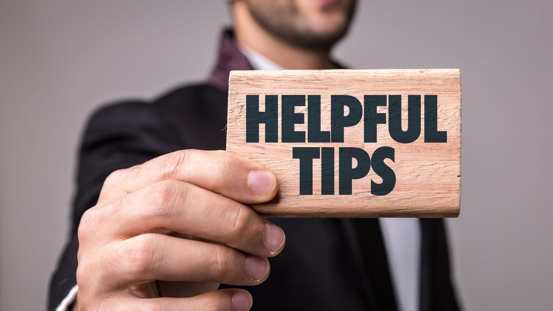 person holding a sign that says expert tips