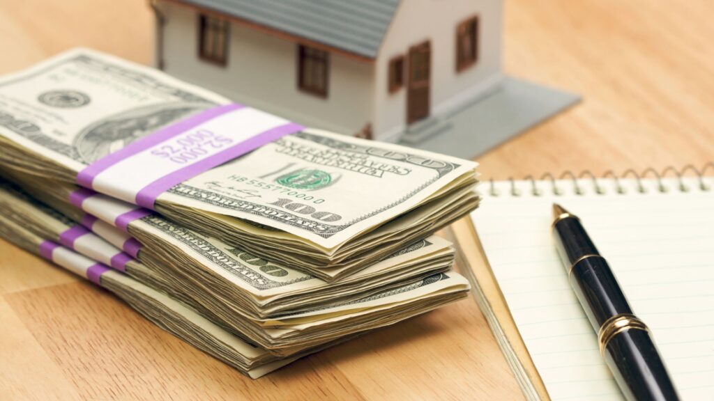 Money on a table with a notepad