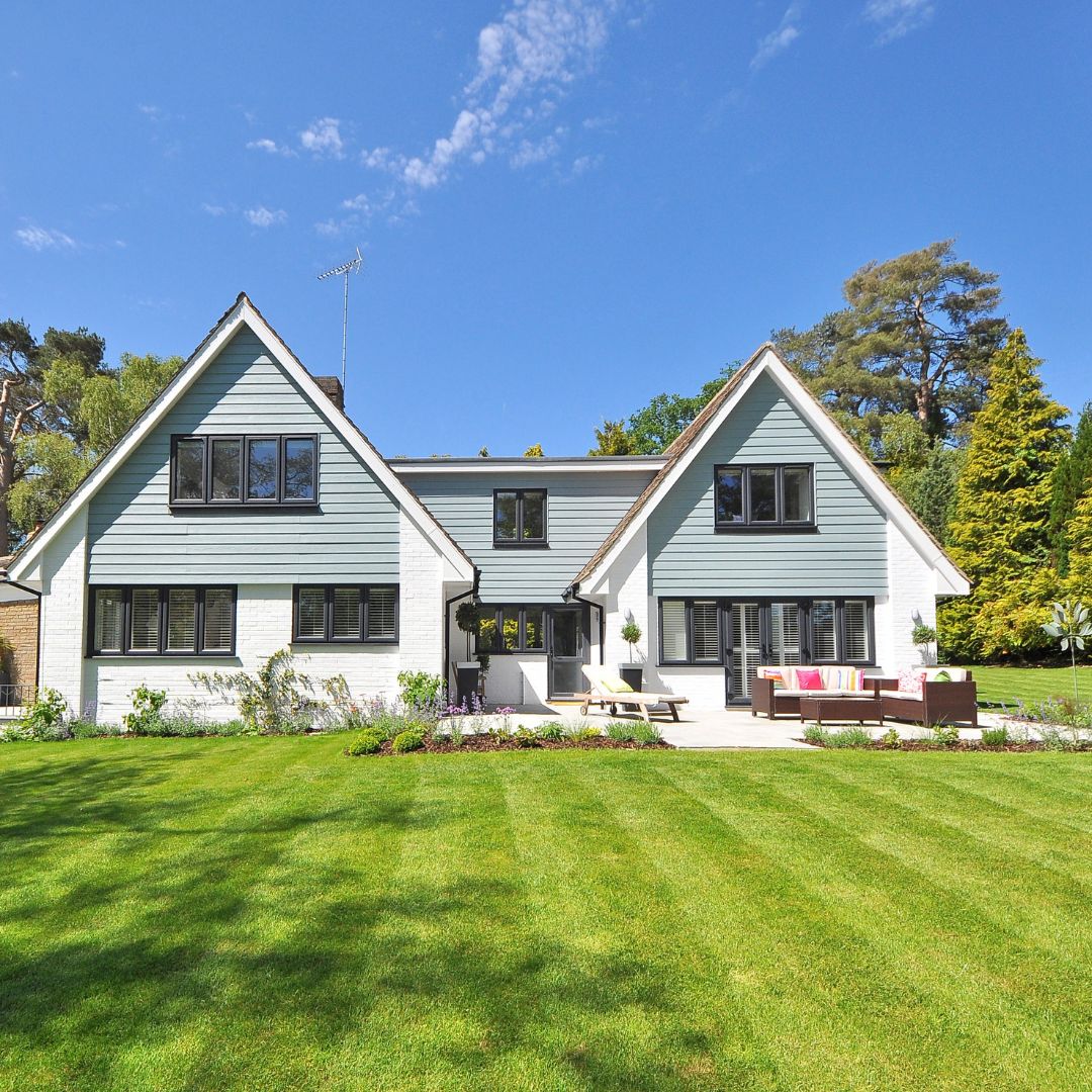 a large home with a green lawn
