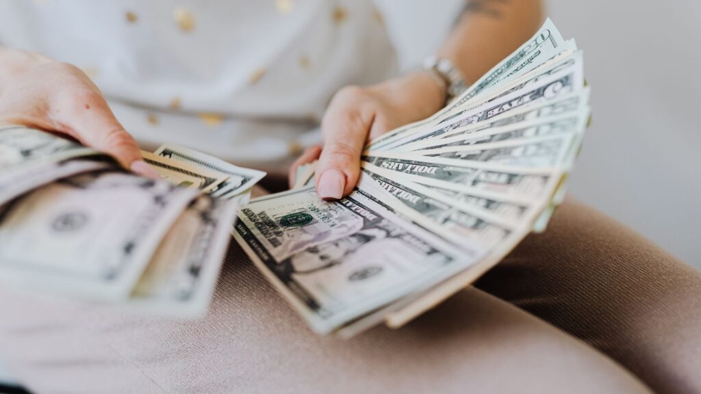 a person counting dollars