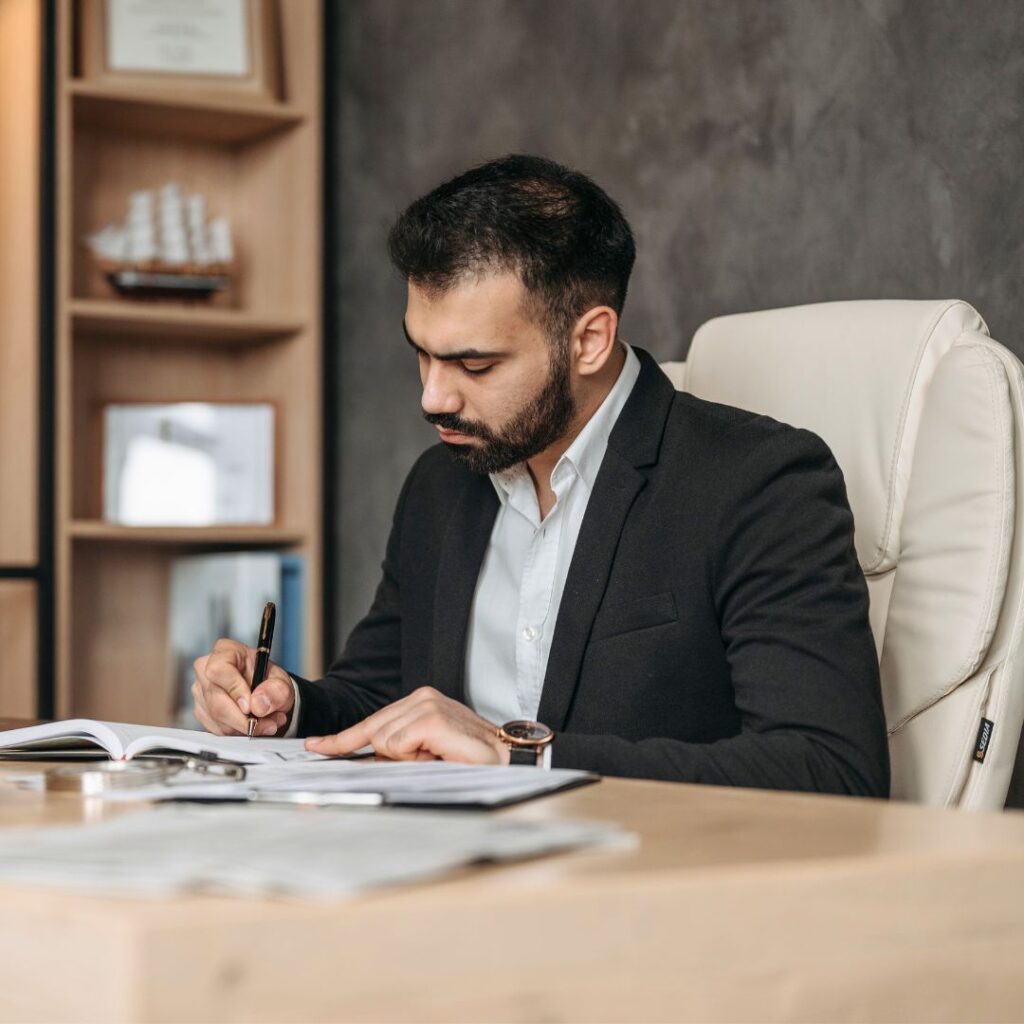 A man signing paperwork