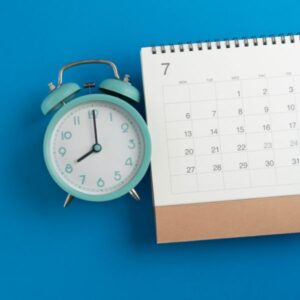 A clock next to a calender
