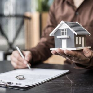 A figure of a home being held